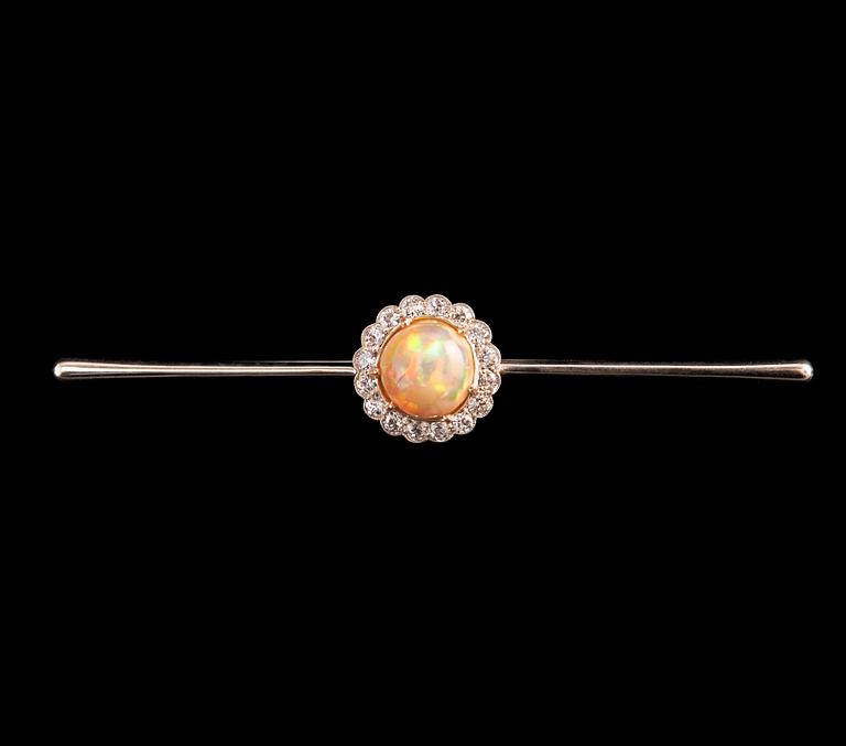 A BROOCH, Brilliant cut diamonds c. 0.65 ct, Opal 10 mm. 14K gold. Unmarked. Length 85 mm, weight 8,2 g.