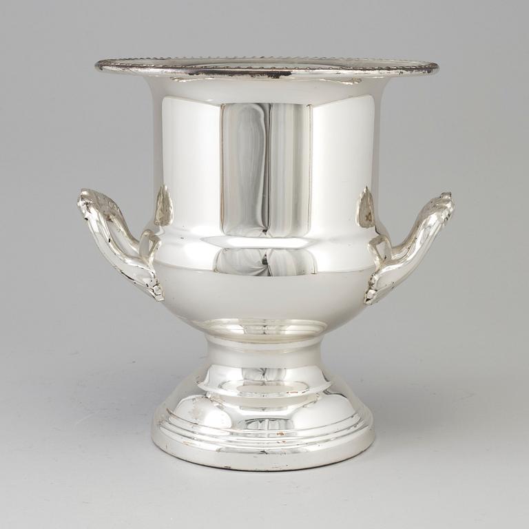 A 20TH CENTURY SILVERVED METAL CHAMPAGNE COOLER.