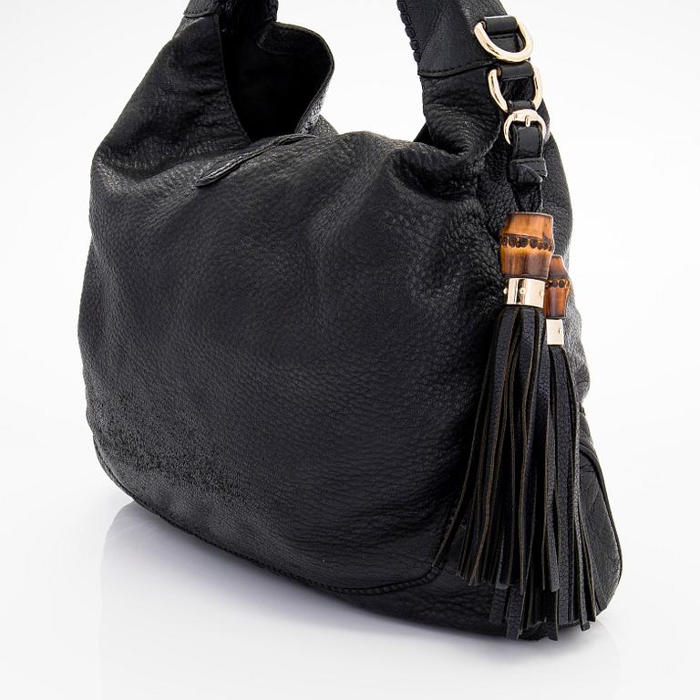 Gucci, a 'Bamboo Jackie Tassel' shoulder bag.