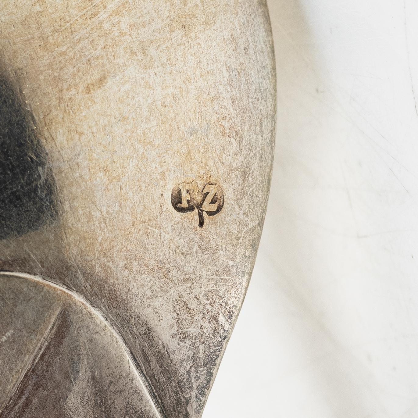 Two silver serving spoons with pseudo-marks, around the year 1900.