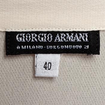 GIORGIO ARMANI, a light beige silk blouse.