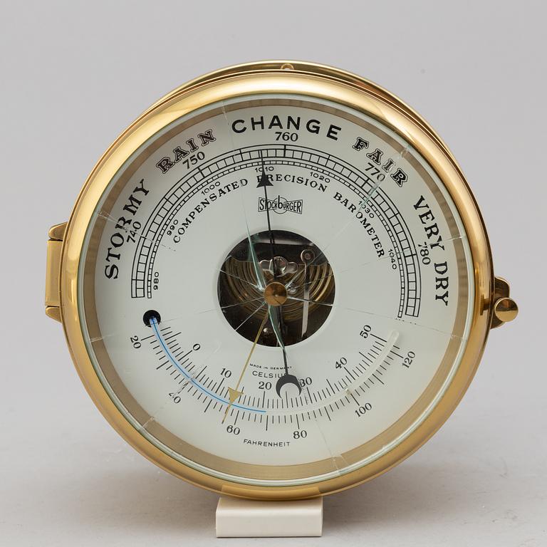 A BRASS MARINE CLOCK AND BAROMETER BY STOCKBURGER.