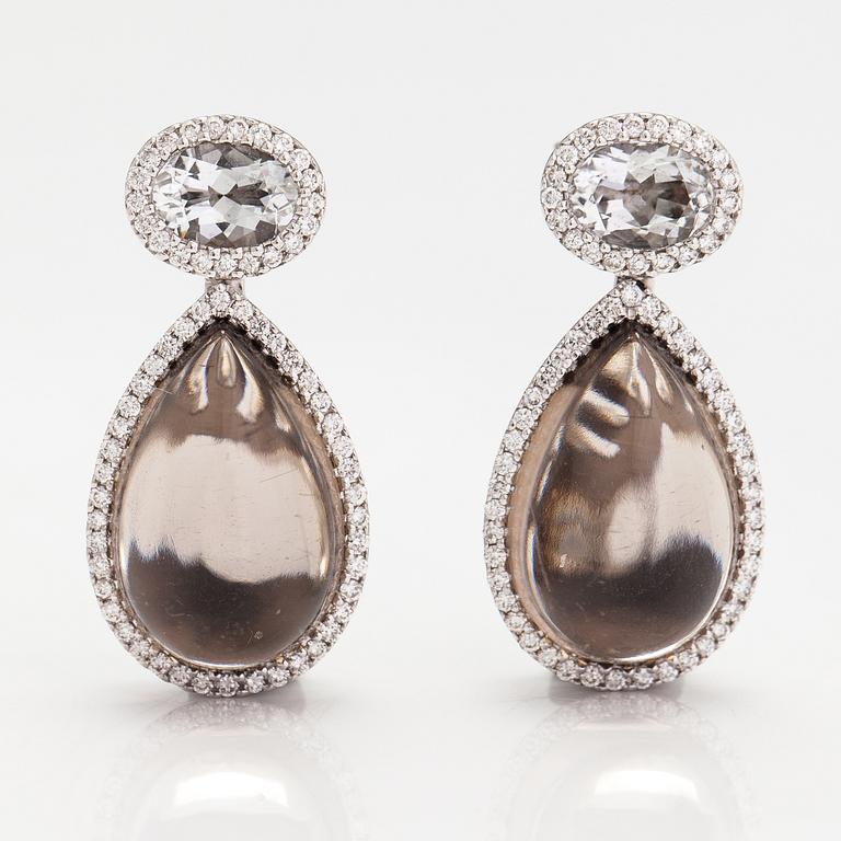 A pair of 18K white gold earrings with diamonds ca. 0.64 ct in total, smoky quartzes and topazes. Tirisi, The Netherland.