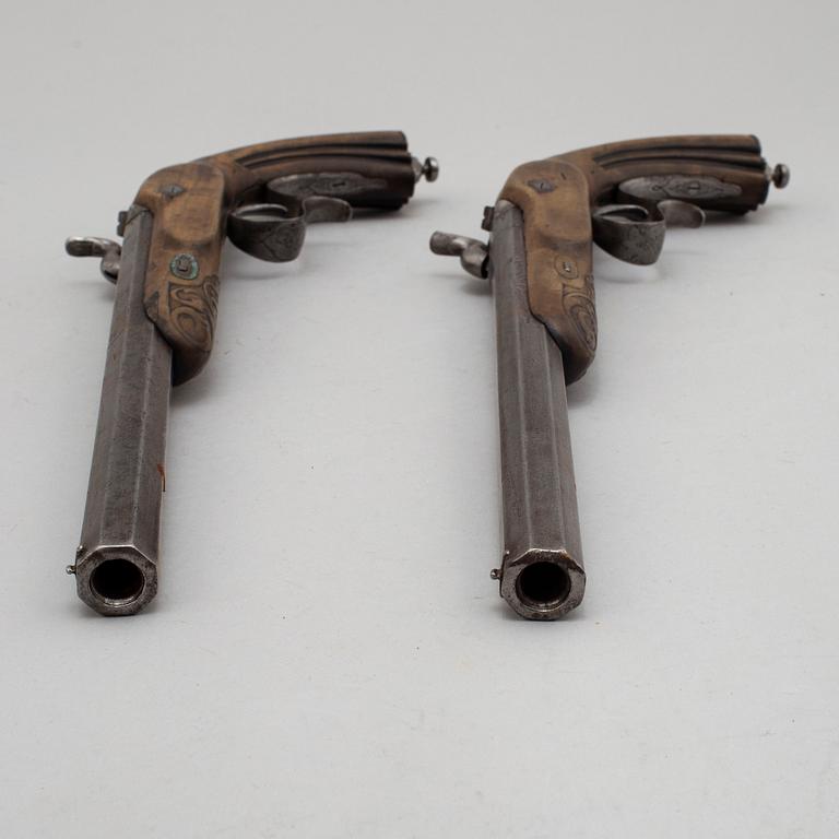 A pair of mid 19th century percussion pistols in a case marked Campagnac a Bordeaux.