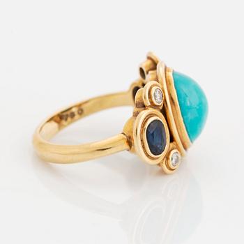 An 18K gold and turquoise Grima ring set with faceted sapphires and round brilliant-cut diamonds.