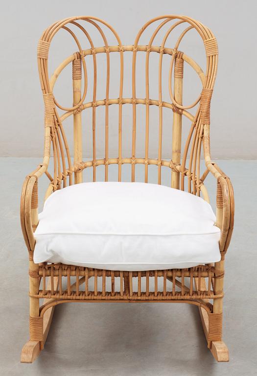 A Josef Frank ratten and beech rocking chair, Svenskt Tenn, model 1077, 1940's-50's.