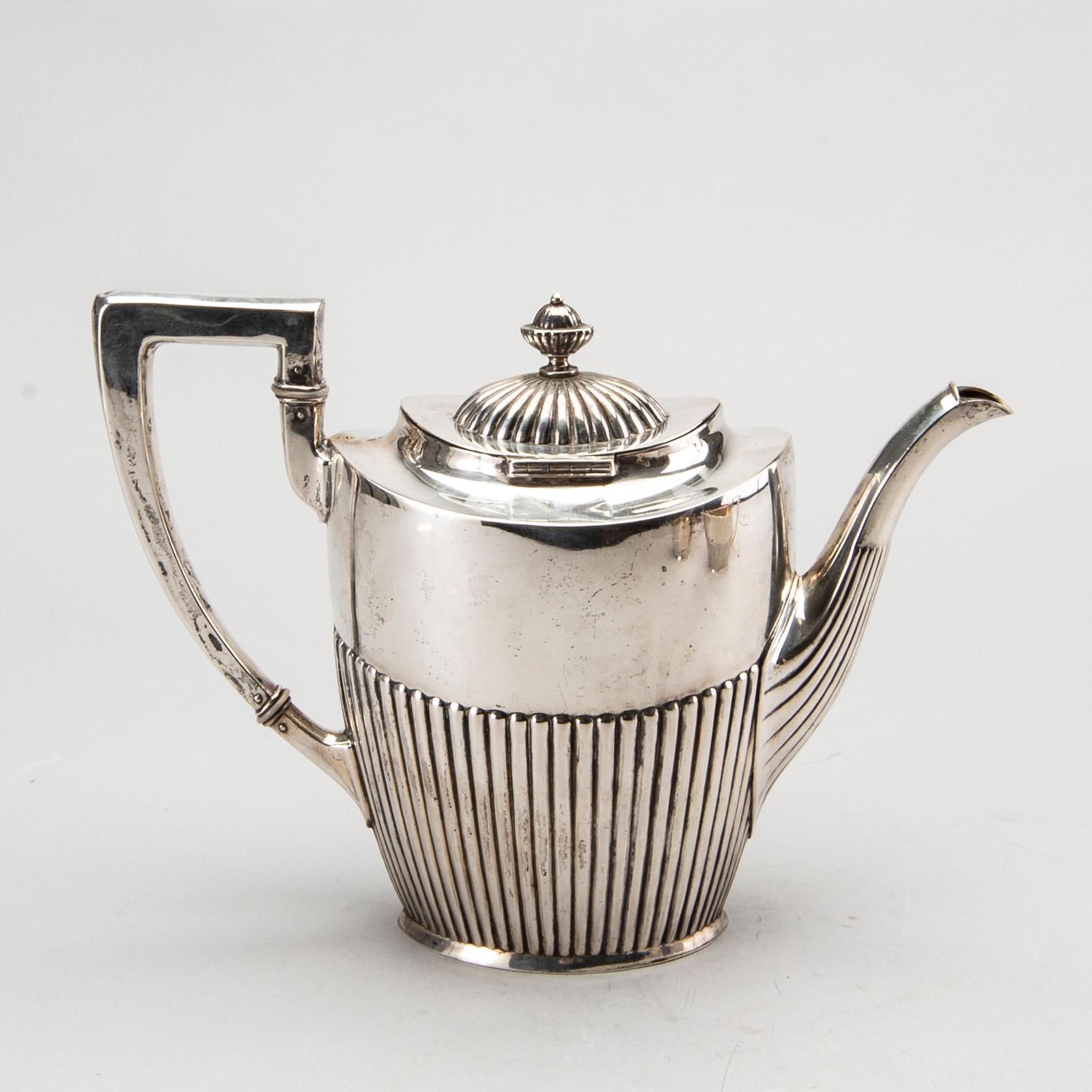 A three piece silver coffee service mark of CG Hallberg Stockholm 1916, weight 896 gram.
