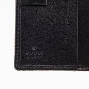 Gucci, a leather and canvas wallet, 1999.