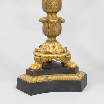 A pair of French Empire-style patinated and gilt bronze five-light candelabra, later part 19th century.