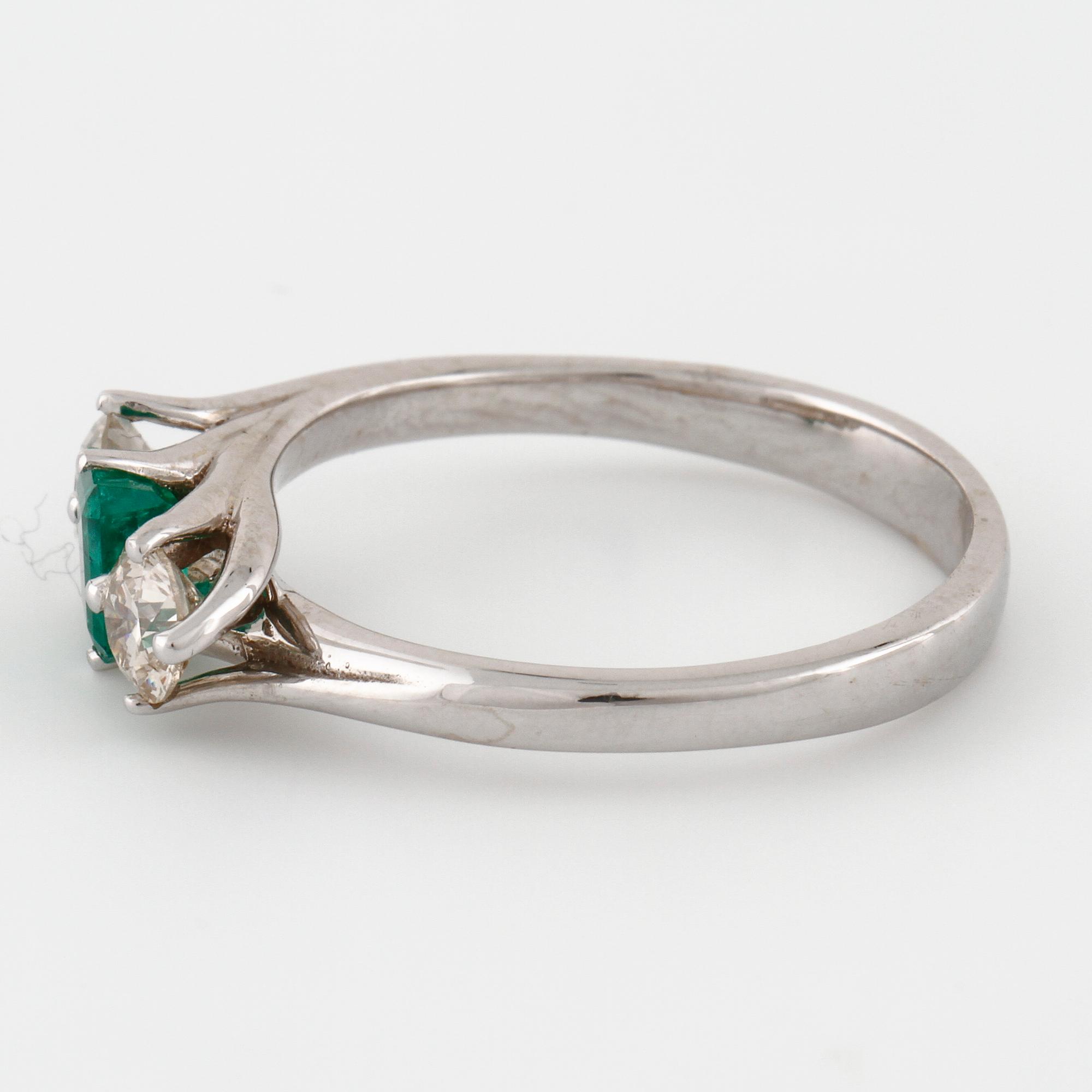 A emerald and brilliant cut diamond ring.