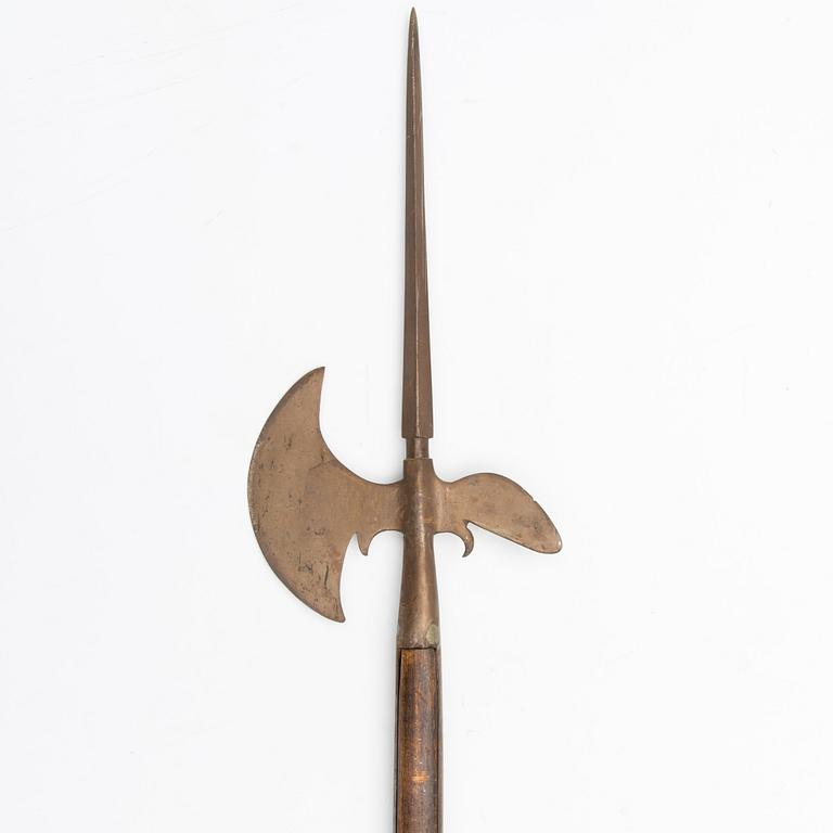 An 20th Century wood and iron halberd.