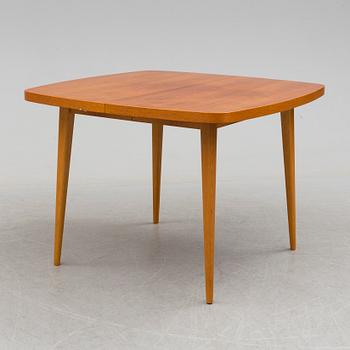 A 1950s teak and teak veneer table.