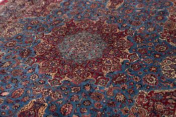 A Mashad carpet, signed Saber, c. 468 x 348 cm.