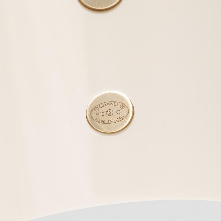 Chanel, a white acrylic bracelet with pearls, 2019.