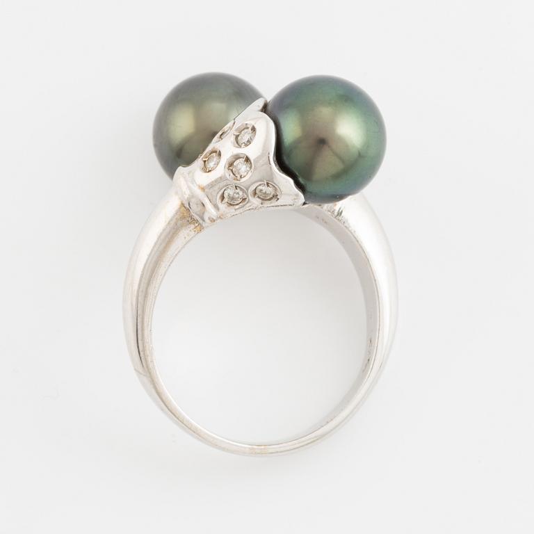 Cultured black pearl and brilliant cut diamond cross over ring.