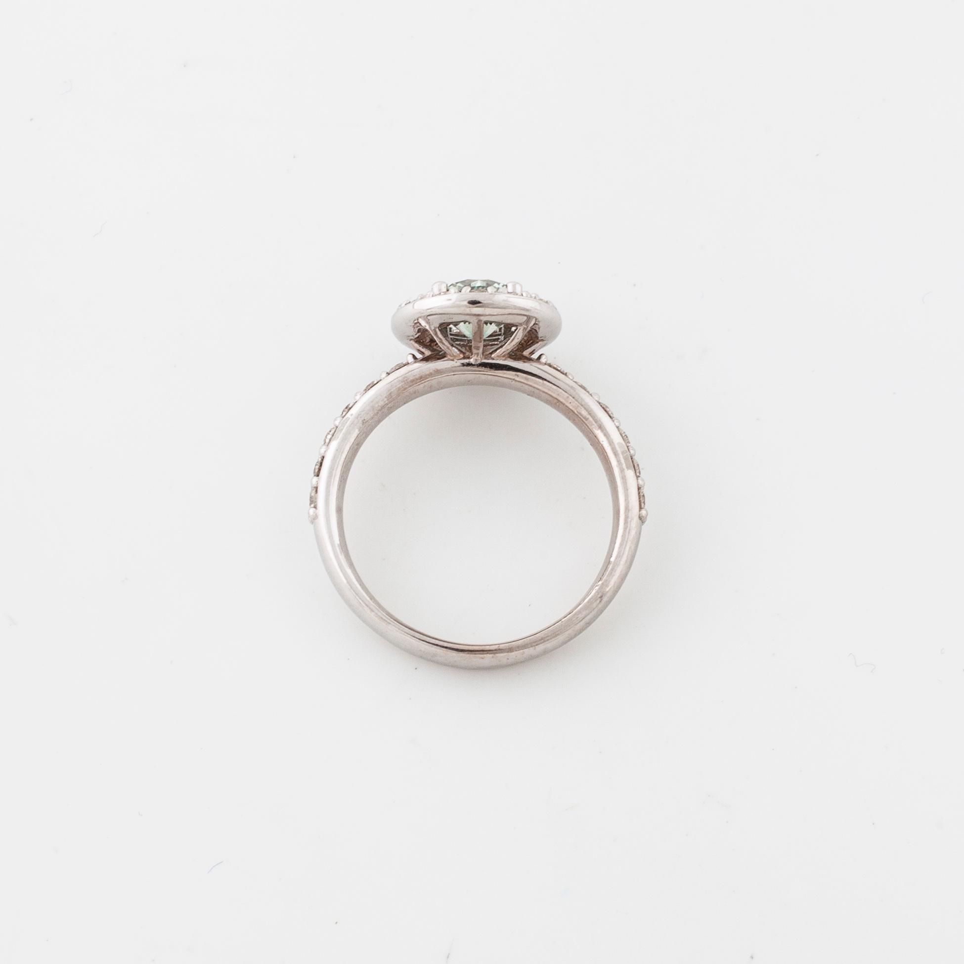 A treated green diamond and briliant cut diamonds.