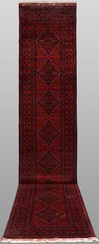 A Afghan runner carpet, 388 x 79 cm.