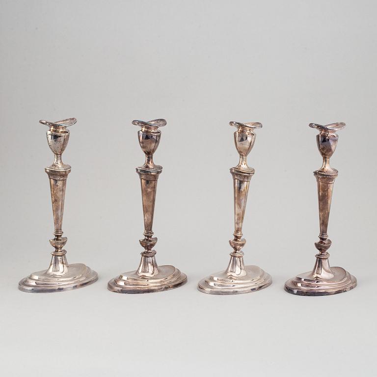 A set of four English 19th century silver-plated candlesticks.