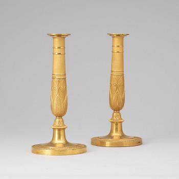 A pair of French Empire early 19th century gilt bronze candlesticks.