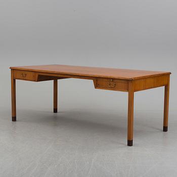 A teak veneered desk, 1950's.