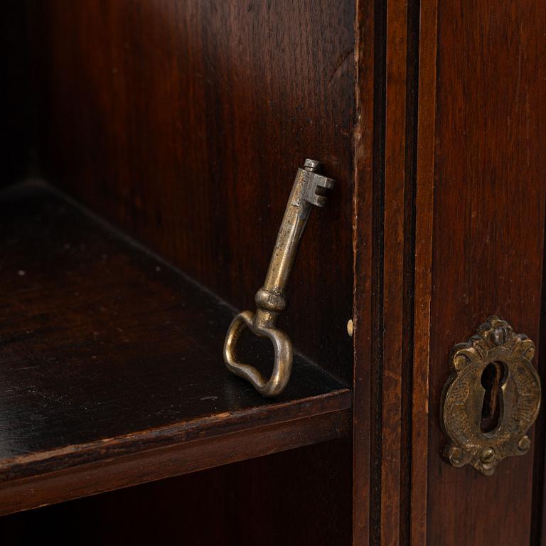 A corner cabinet, Liberty & Co, England, circa 1900.