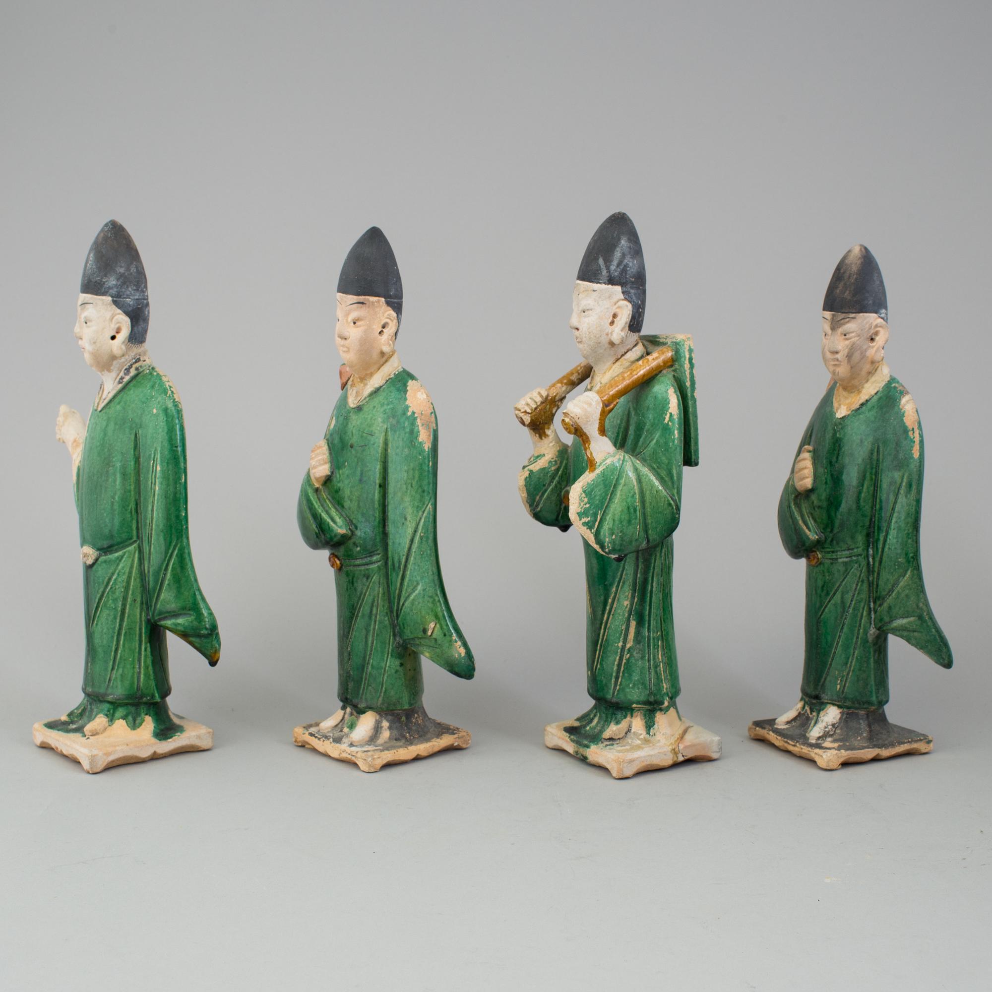 A group of eight chinese figures with three objects, earthenware, Ming dynasty.
