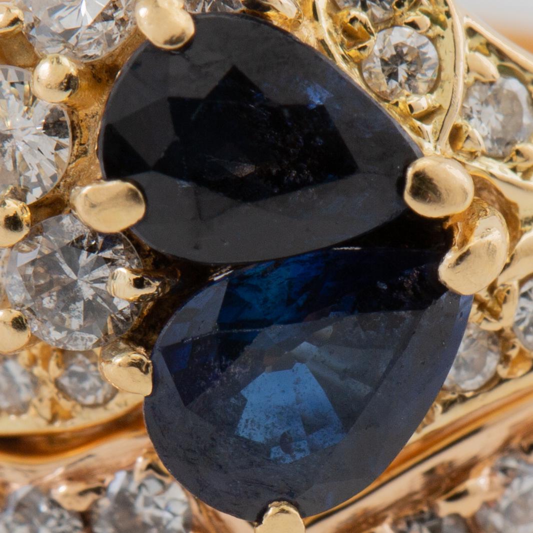 Ring in 18K gold set with pear-shaped sapphires and round brilliant and single-cut diamonds.