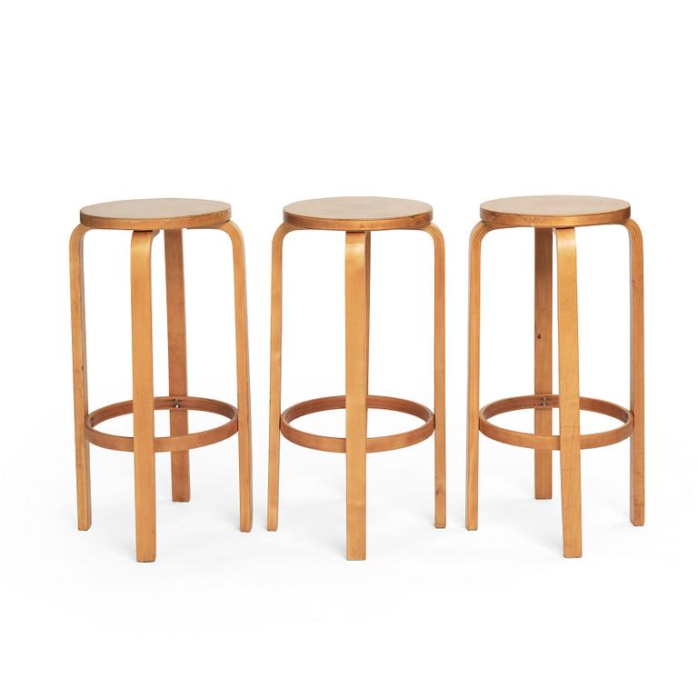 Alvar Aalto, a set of three bar stools, model "64", Finmar Ltd, Finland 1930s.