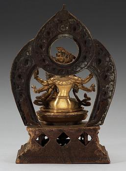 A large gilt bronze Nepal/Sino-Tibetan figure of Buddha, Qing dynasty, presumably Qianlong (1736-95). With an inscription around the base.