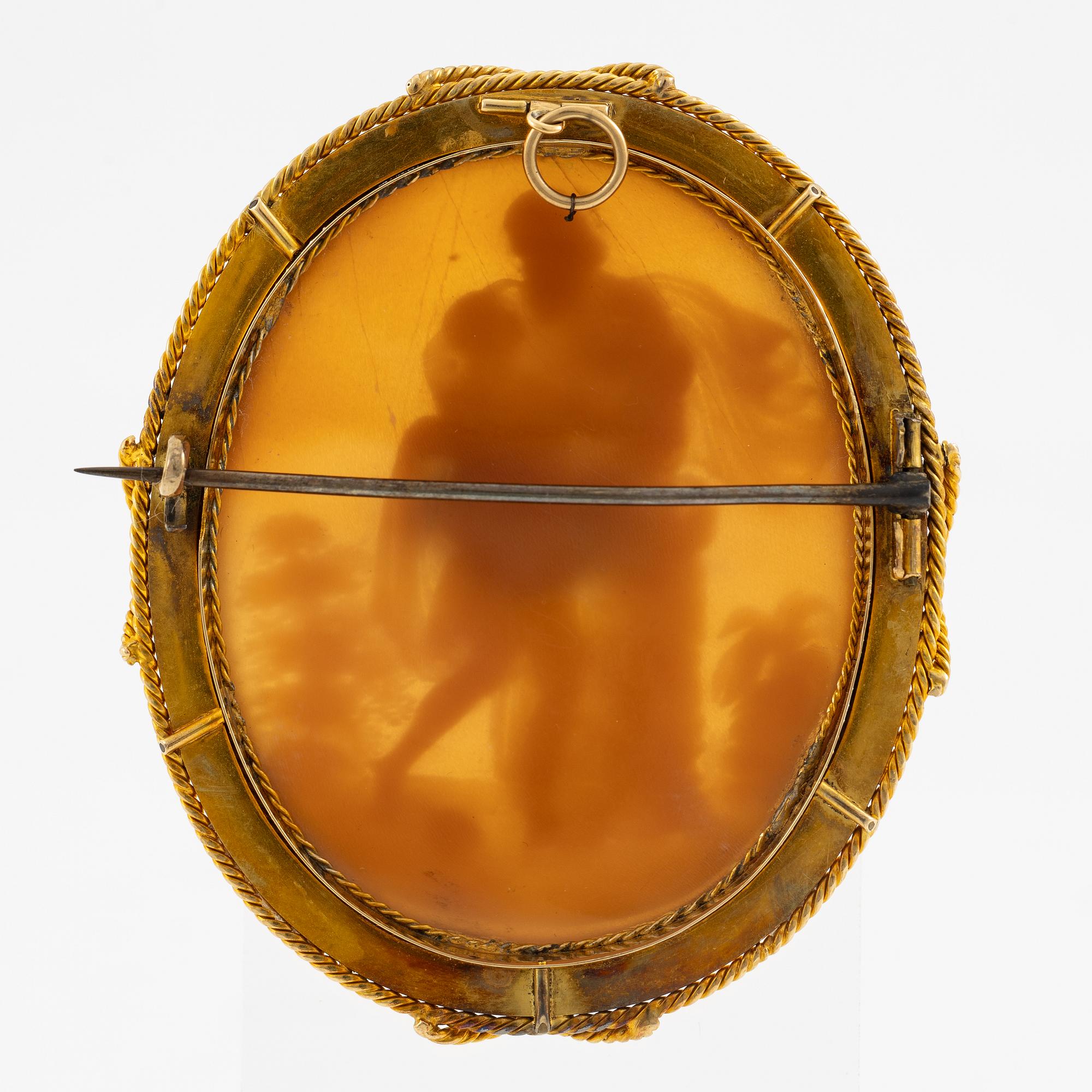 A brooch with a large shell cameo.
