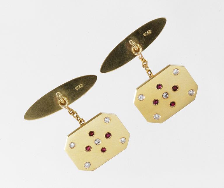 A pair of gold, ruby and diamond cuff links.