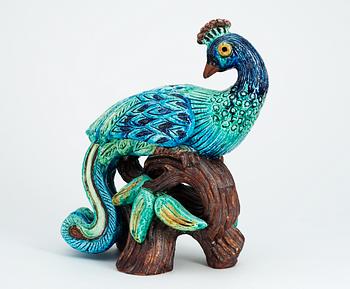 A Gunnar Nylund stoneware figure of a peacock.