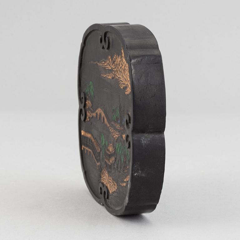 A Chinese ink-cake, with calligraphy and decorated with an ox, 20th Century.