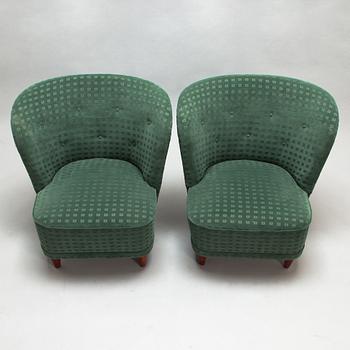 A pair of mid-20th-century armchairs.