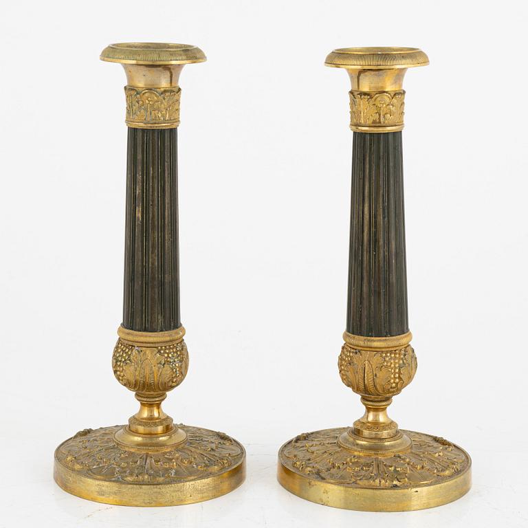 A pair of French Empire ormolu and patinated bronze candlesticks, first part of the 19th century.