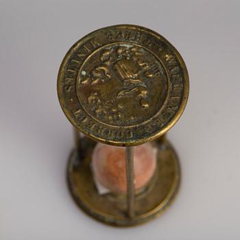 A brass cork screw and hourglass 19th century.