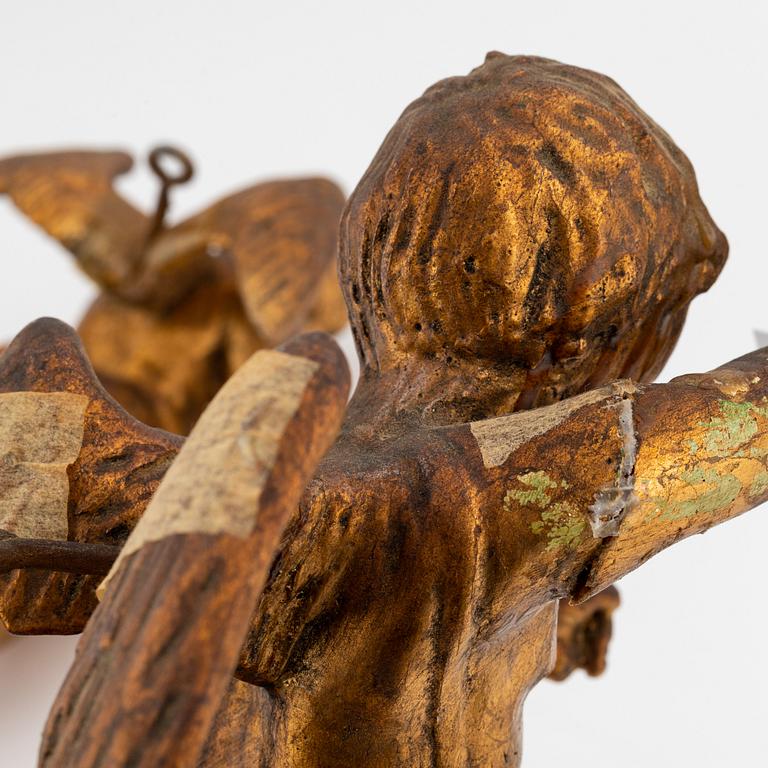 A pair of baroque wooden cupid sculptures, 18th century.