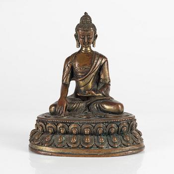 A cold gilt copper alloy figure of buddha Shakyamuni, Tibet, early 20th Century.