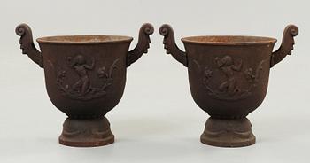 A pair of Ivar Johnsson 'Faun' cast iron urns, Näfveqvarns Bruk.