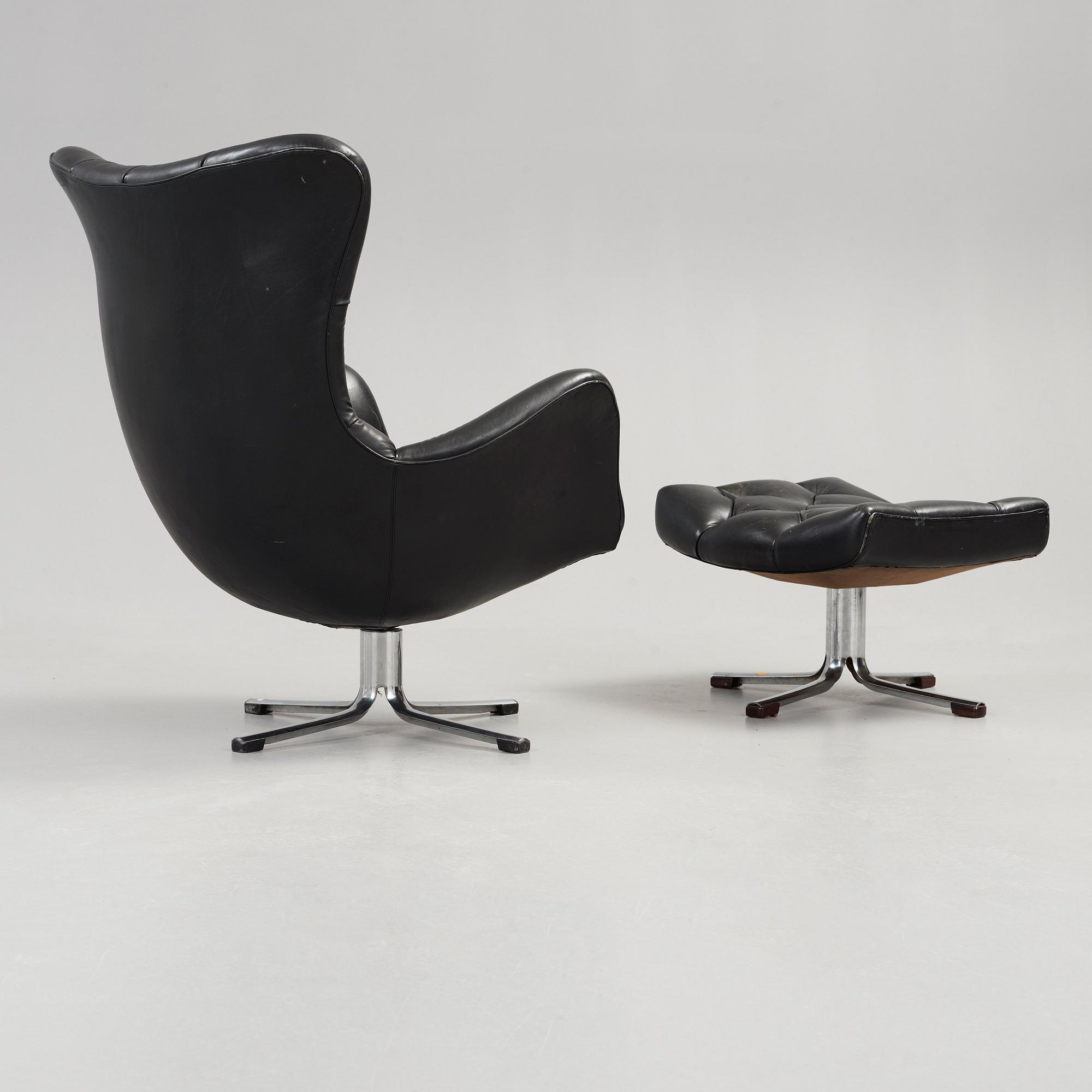A Gustav Axel Berg 'Status' black leather easy chair with ottoman, Bröderna Andersson 1960's-70's.