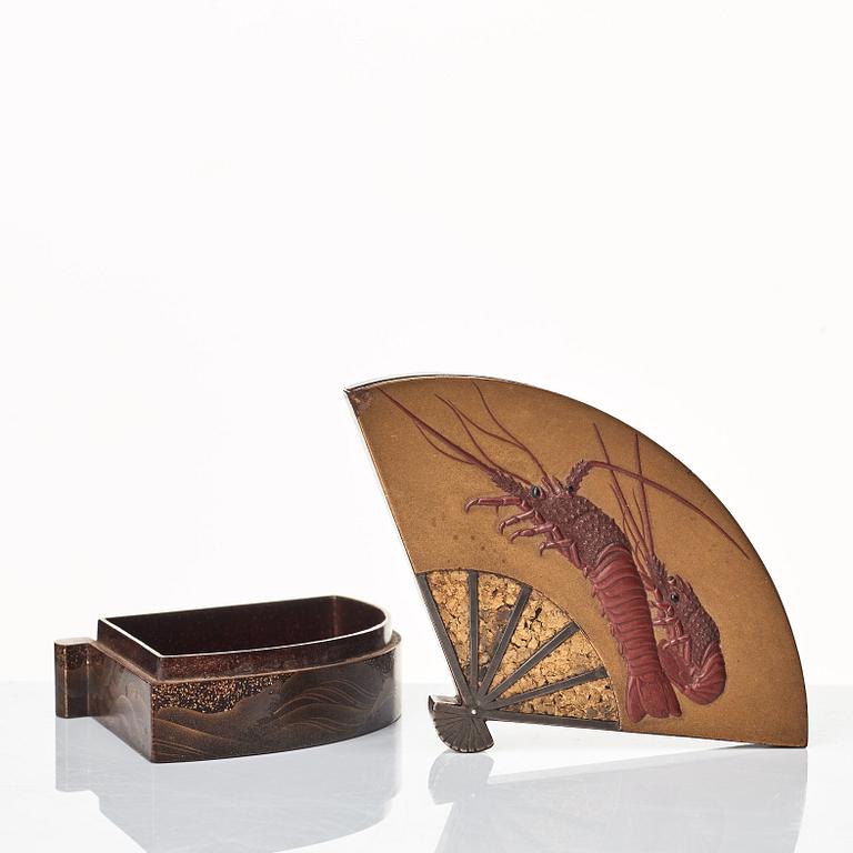 A carved red lacquer Tsuishu and metalwork Kagamibuta Netuske and a box with cover, Japan, 19th Century.