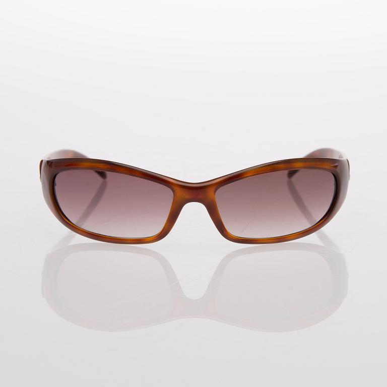 Two Pairs of Sunglasses, Prada and Chanel.