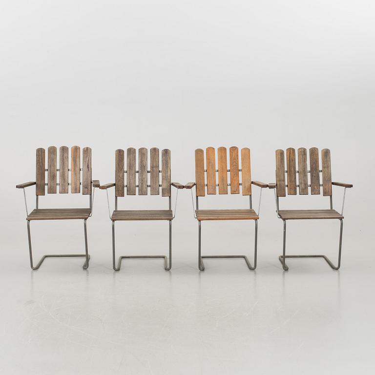 A GARDEN TABLE AND FOUR ARMCHAIRS FORM GRYTHYTTAN.