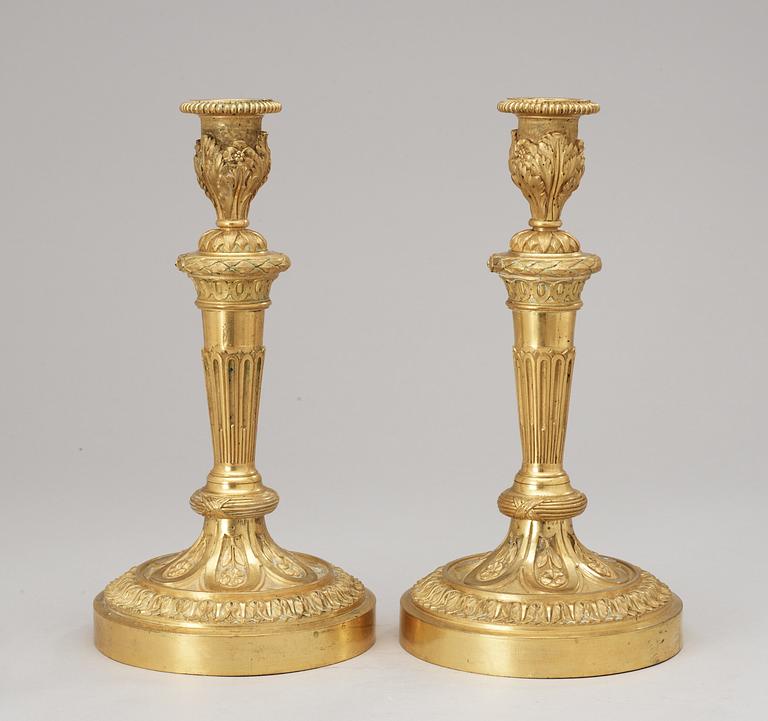 A pair of Louis XVI-style 19th Century candlesticks.