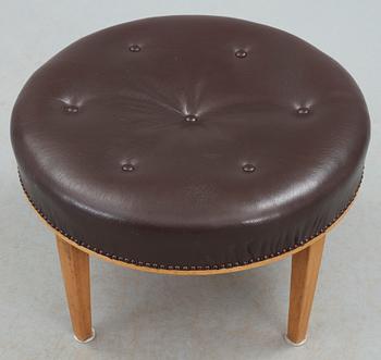 A Josef Frank mahogany and brown leather stool by Svenskt Tenn.