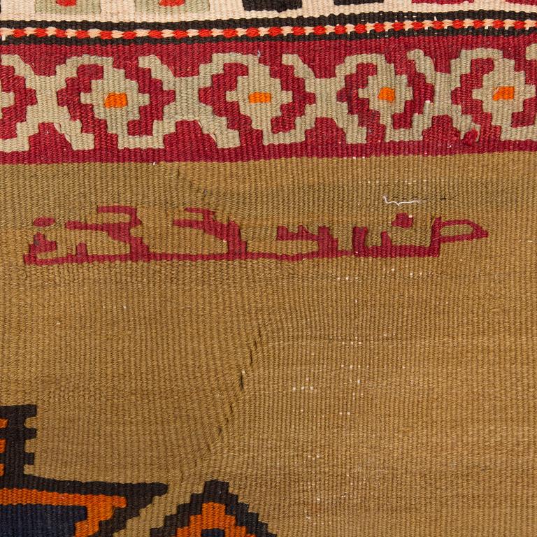 A persian kilim, around 312 x 170 cm.