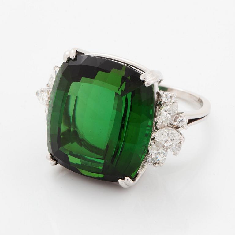 An 18K white gold ring set with a green tourmaline and round- and marquise brilliant-cut diamonds.