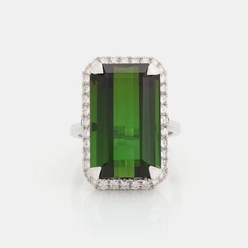 521. An 18K white gold ring set with a step-cut green tourmaline and round brilliant-cut diamonds.