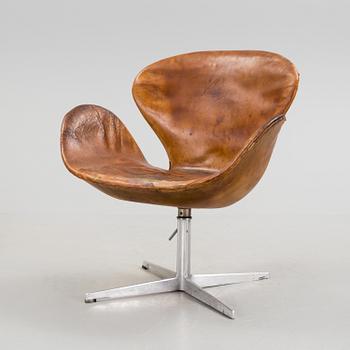 An Arne Jacobsen steel and brown leather 'Swan' chair, Fritz Hansen, Denmark 1960's.