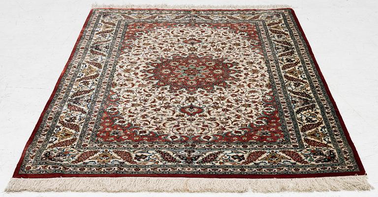 A Ghom silk rug, signed, c. 148 x 100 cm.